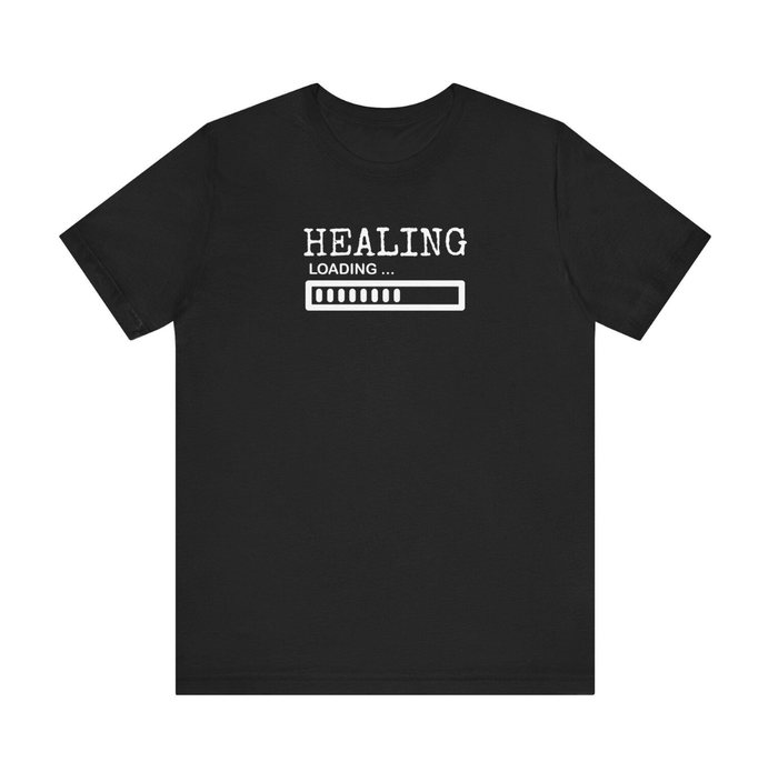 Black T-shirt printed “HEALING” over a loading bar